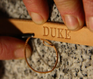 Hand showing how a collars is edged